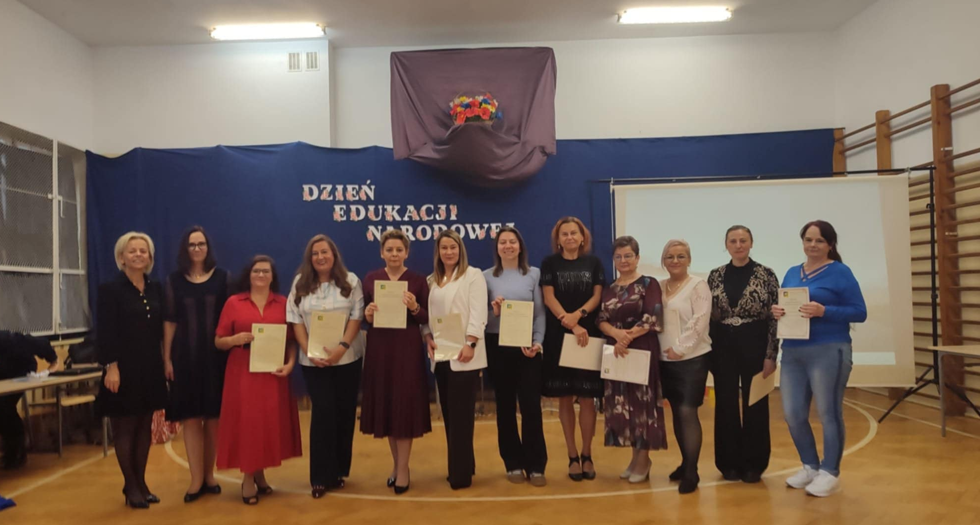 Pracownicy i pani dyrektor szkoły podczas Dnia Edukacji Narodowej